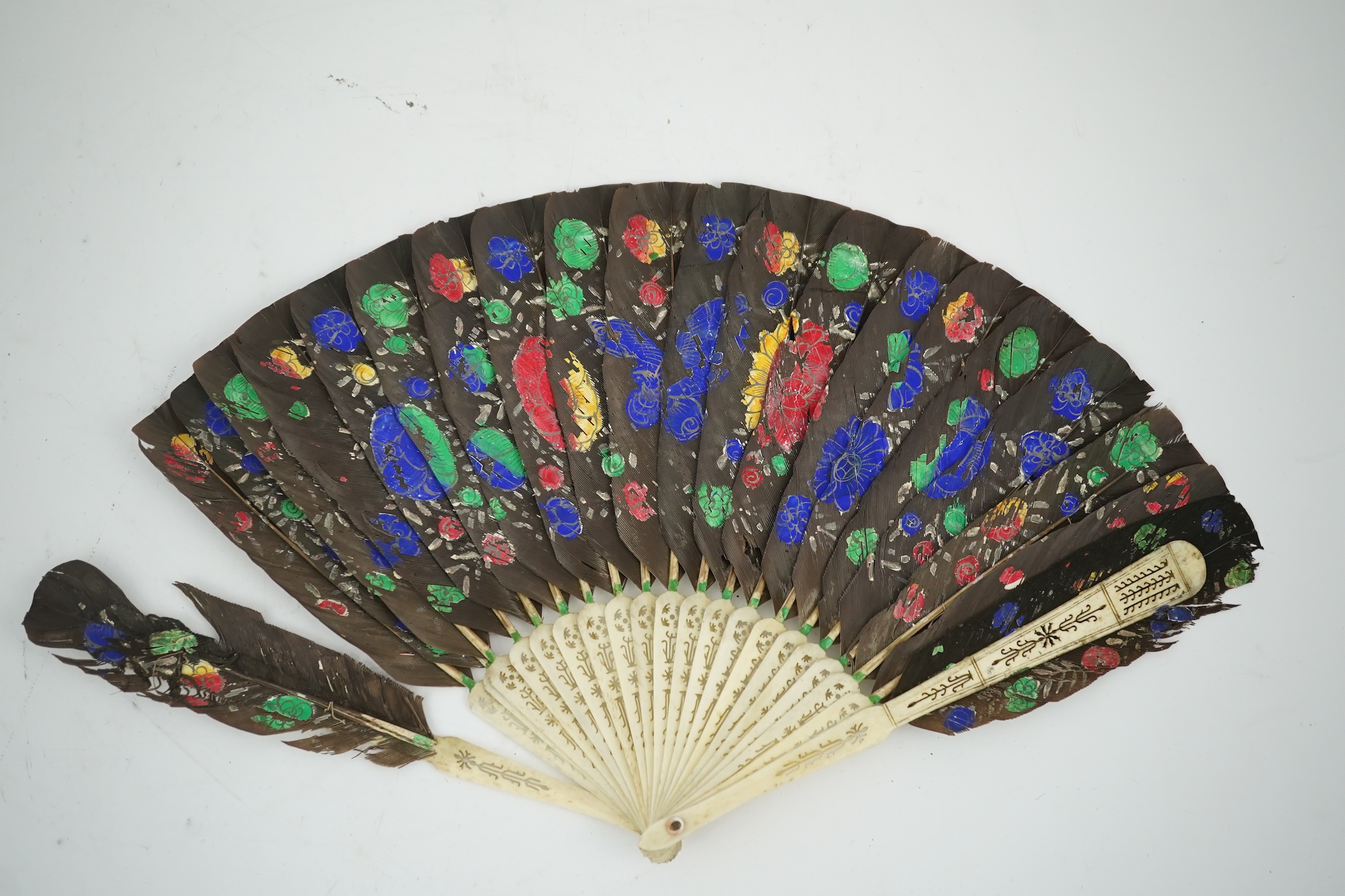 Three 19th century Chinese feather fans: One a carved bone brise black feather fan together with two similar carved sandalwood feather fans, two fans have hand painted decoration on the feathers both sides, the pink feat